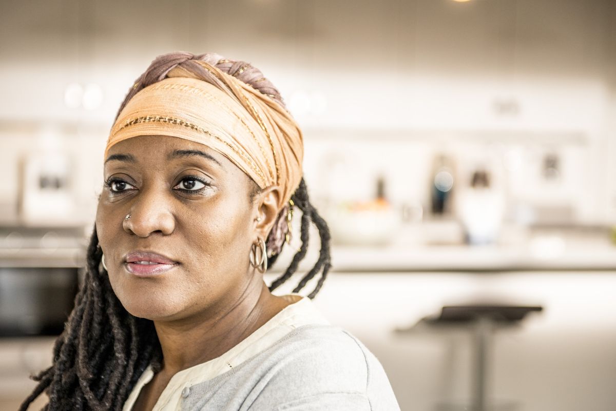 This image is of a black woman patient in deep thought or reflection.